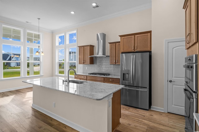 1228 Colusa Ct, Little River, SC 29566 - kitchen with stainless steel appliances, wall chimney range hood, ornamental molding, brown cabinetry, and wood finished floors