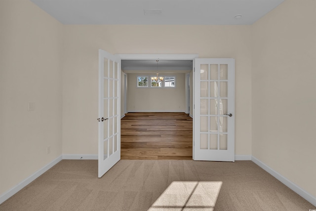 1228 Colusa Ct, Little River, SC 29566 - spare room with french doors, a chandelier, and carpet