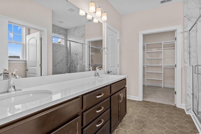 1228 Colusa Ct, Little River, SC 29566 - bathroom featuring a spacious closet, double vanity, and a marble finish shower