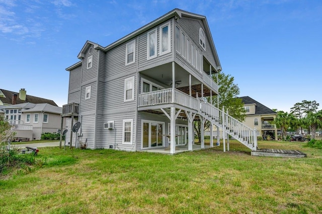 back of house with a patio and a lawn