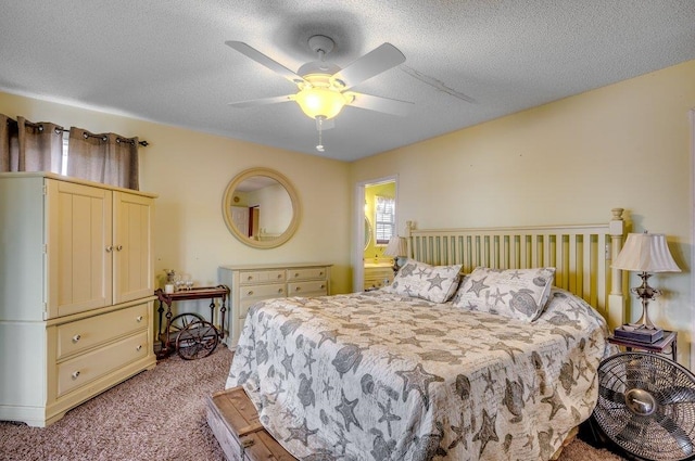 carpeted bedroom with a textured ceiling and ceiling fan