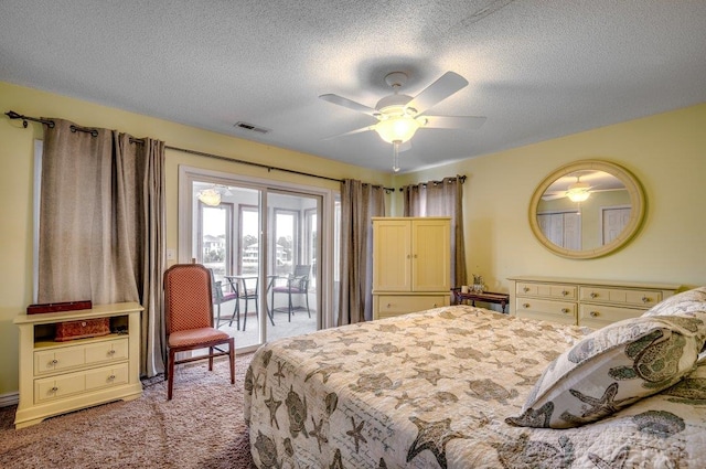 carpeted bedroom with ceiling fan and a textured ceiling