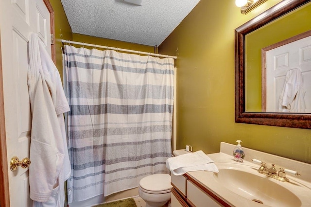 bathroom with toilet, a textured ceiling, and vanity