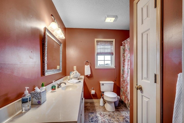 bathroom with tile floors, toilet, oversized vanity, and a textured ceiling