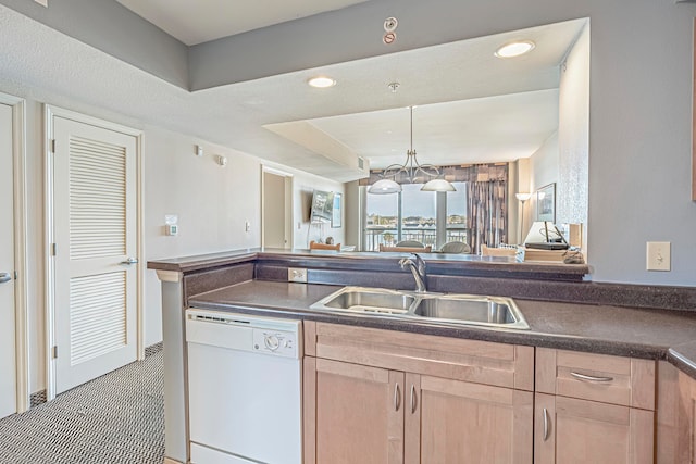 kitchen with light brown cabinetry, sink, light tile floors, white dishwasher, and an inviting chandelier