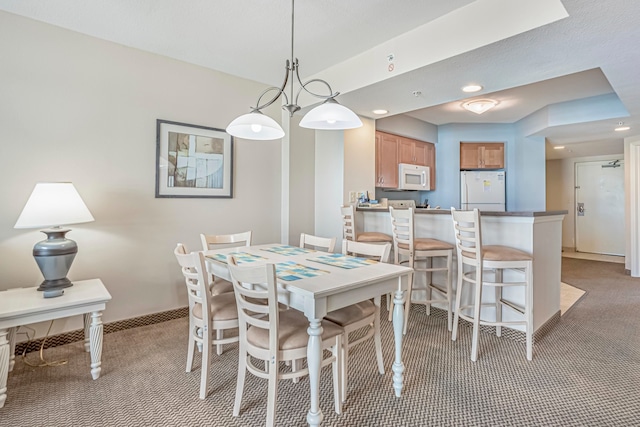 carpeted dining space with an inviting chandelier