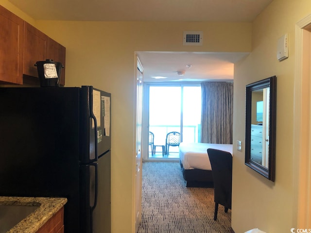 hallway with carpet flooring and sink