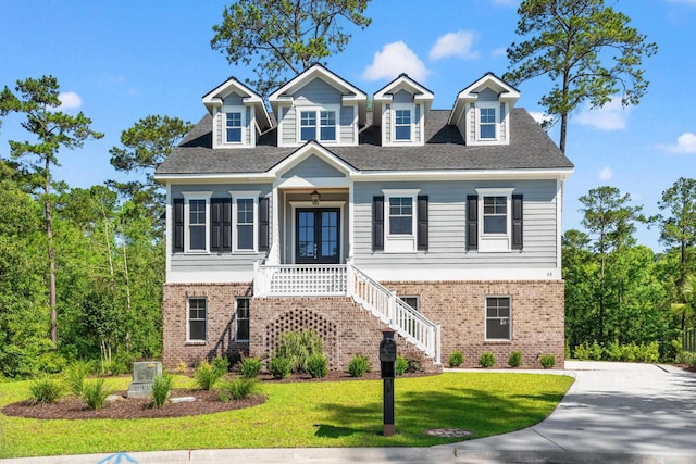 view of front of home featuring french doors and a front lawn