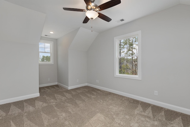 bonus room featuring vaulted ceiling, carpet, ceiling fan, and a wealth of natural light