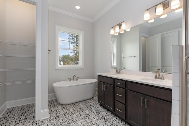 bathroom with vanity, tile patterned floors, ornamental molding, and a bathing tub