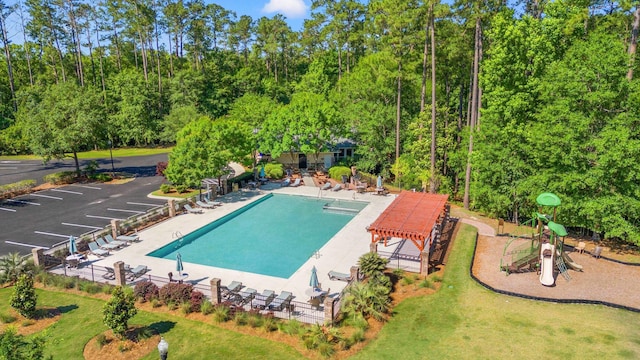 view of pool with a lawn, a patio area, and a pergola