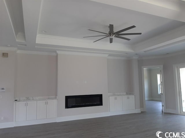 unfurnished living room featuring ceiling fan, ornamental molding, dark hardwood / wood-style floors, and beam ceiling