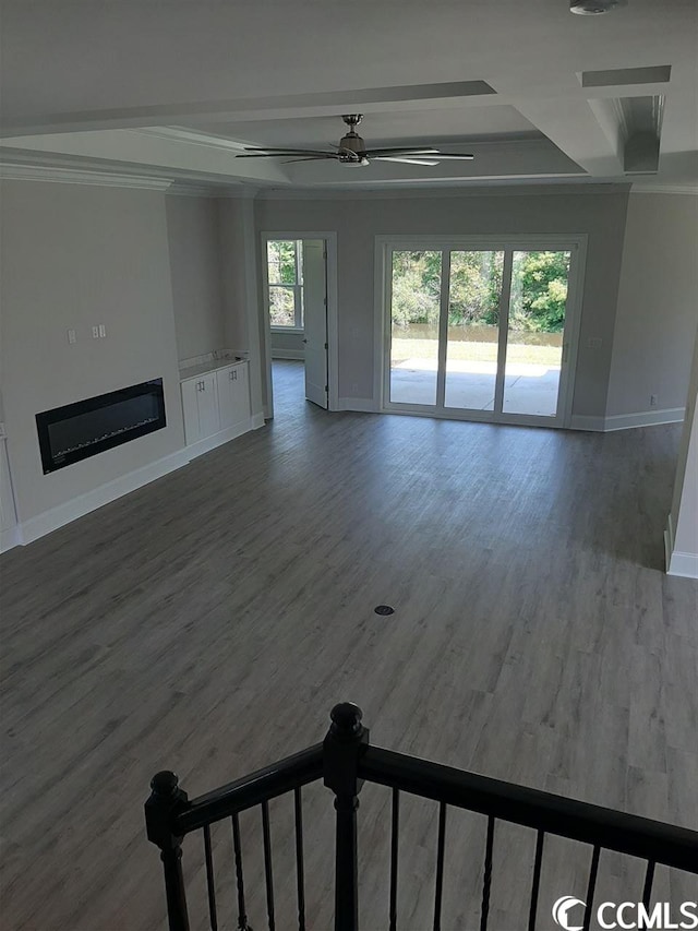 unfurnished living room with ceiling fan and dark hardwood / wood-style floors