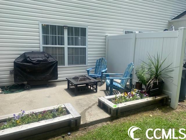 view of patio / terrace with a fire pit and grilling area