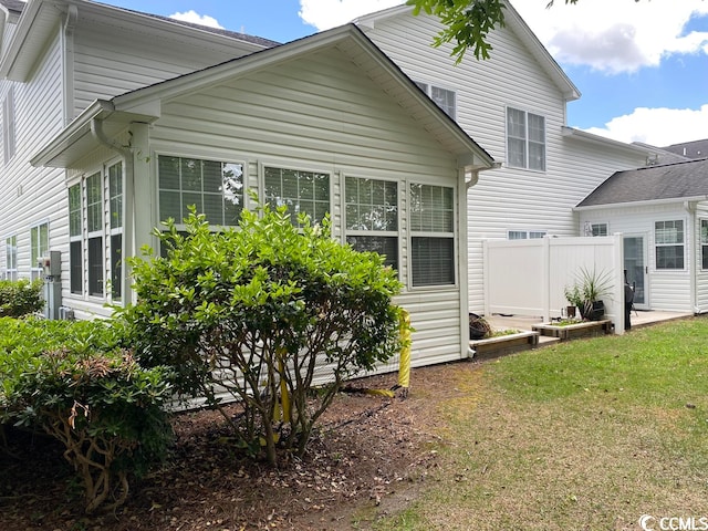 rear view of house with a yard