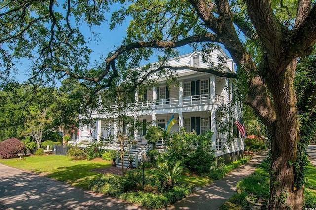 view of front of property with a front lawn and a balcony