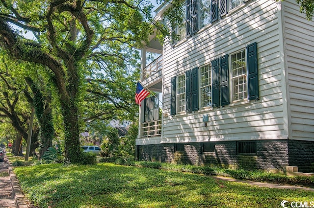 view of home's exterior with a lawn