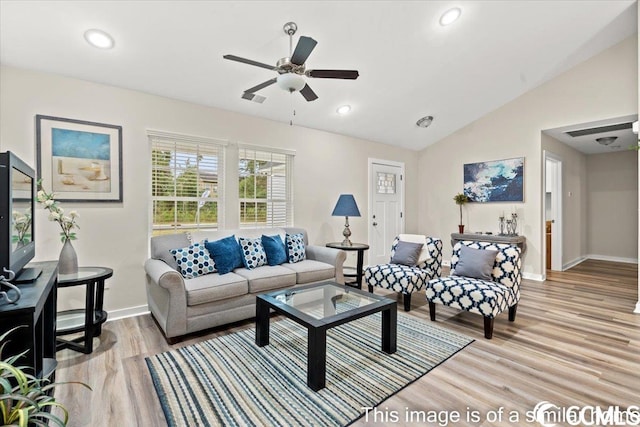 living room featuring vaulted ceiling, light wood-style flooring, recessed lighting, and baseboards