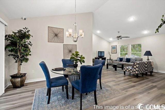 dining area featuring recessed lighting, baseboards, lofted ceiling, and wood finished floors