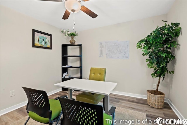 office area with wood finished floors, baseboards, and ceiling fan