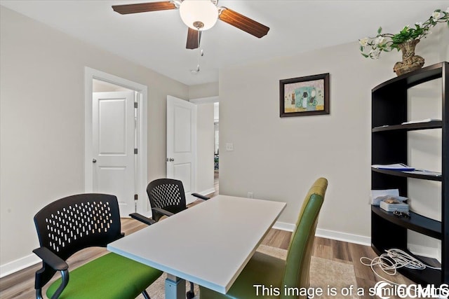 home office featuring ceiling fan, baseboards, and wood finished floors