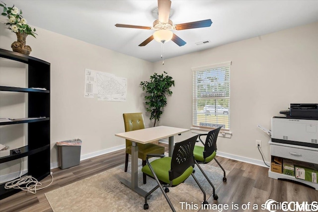 office area with visible vents, a ceiling fan, baseboards, and wood finished floors