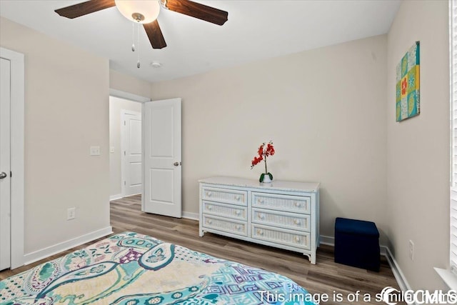 bedroom with ceiling fan, baseboards, and wood finished floors