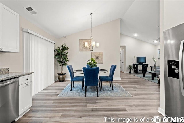 dining room featuring visible vents, high vaulted ceiling, light wood-style floors, an inviting chandelier, and baseboards