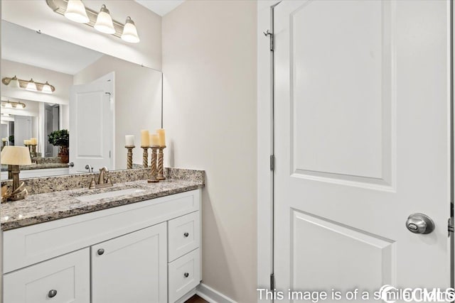 bathroom with vanity and baseboards