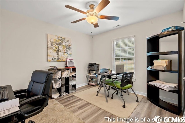 office area featuring visible vents, baseboards, ceiling fan, and wood finished floors