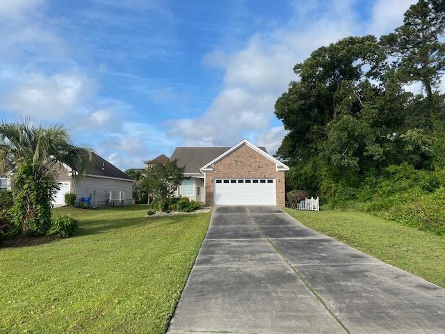 view of front of home with a garage and a front lawn