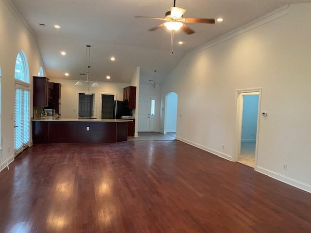 kitchen with black refrigerator, ceiling fan, kitchen peninsula, and dark wood-type flooring