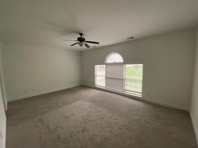 empty room featuring ceiling fan and carpet flooring