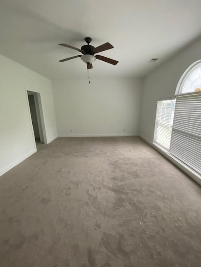 empty room with lofted ceiling and ceiling fan