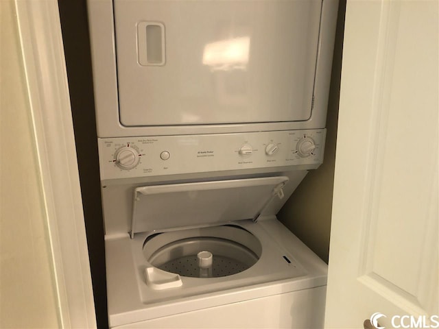 laundry area with stacked washing maching and dryer