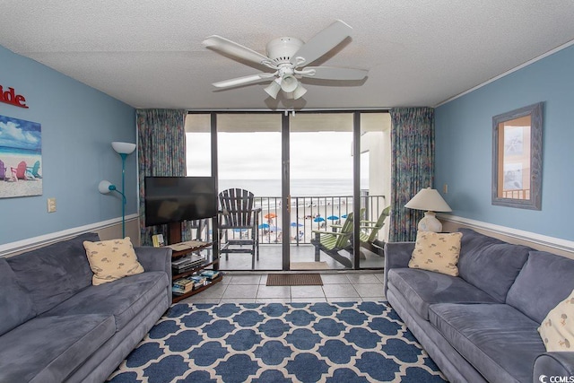 tiled living room with a textured ceiling and ceiling fan