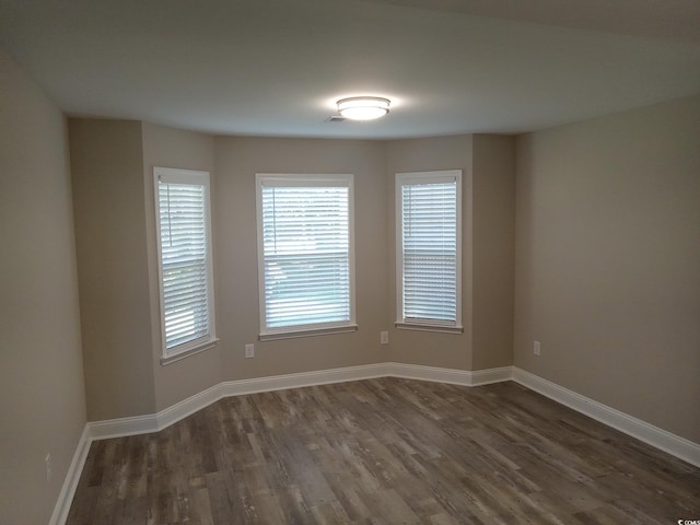 empty room featuring dark wood-type flooring