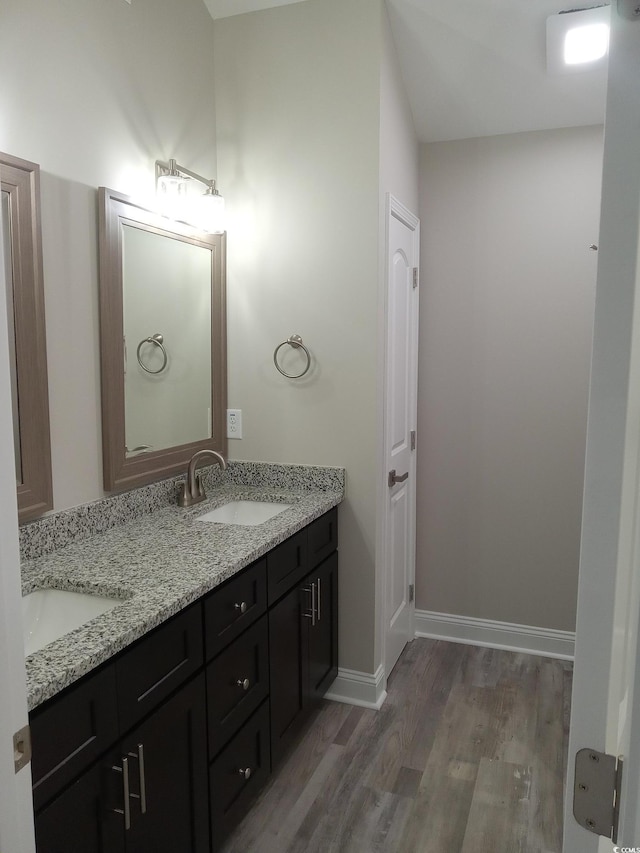 1023 Meares St, Calabash, NC 28467 - full bathroom featuring double vanity, baseboards, a sink, and wood finished floors