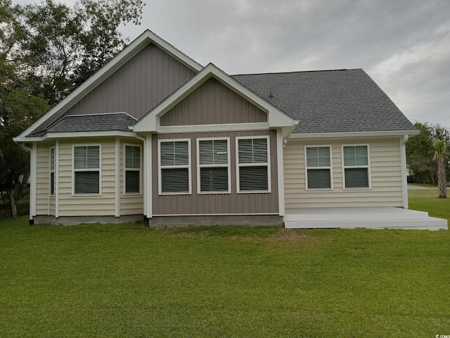 1023 Meares St, Calabash, NC 28467 - back of property with a shingled roof and a lawn