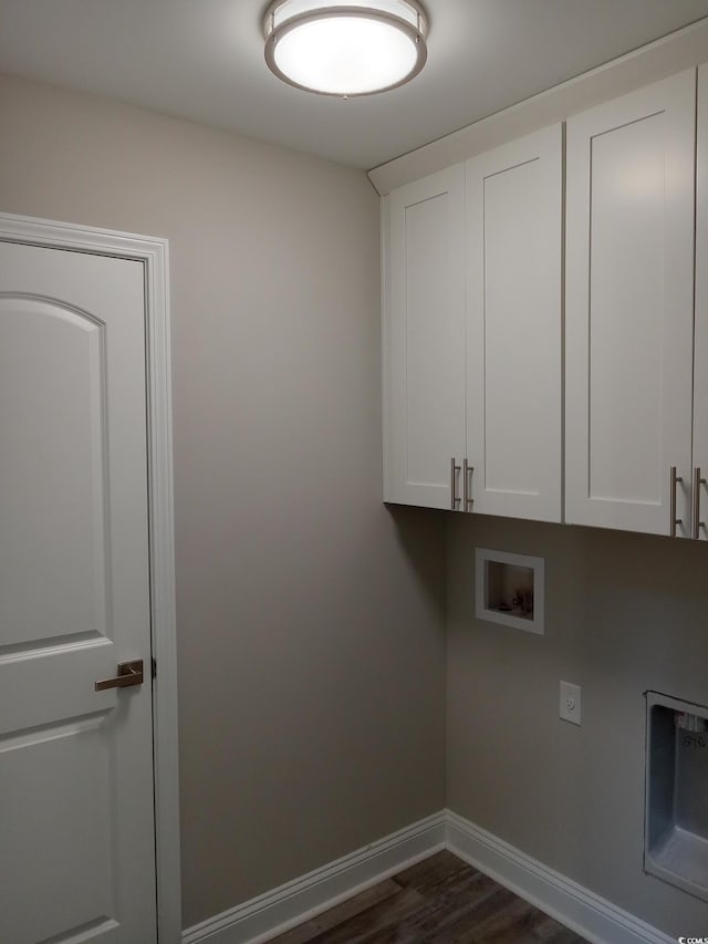 clothes washing area featuring electric dryer hookup, dark hardwood / wood-style floors, cabinets, and hookup for a washing machine