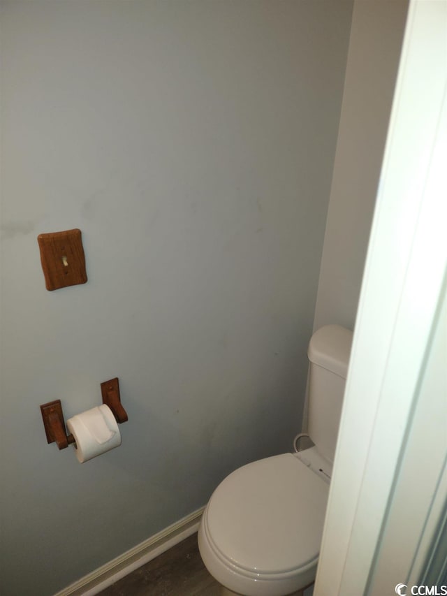 bathroom featuring hardwood / wood-style floors and toilet