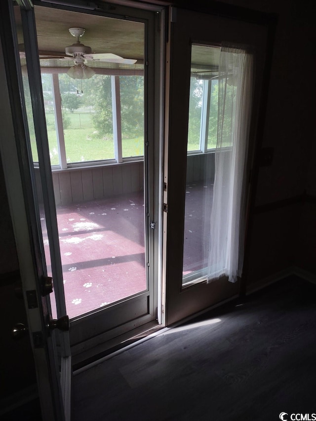 doorway to outside with dark hardwood / wood-style floors, ceiling fan, and a wealth of natural light