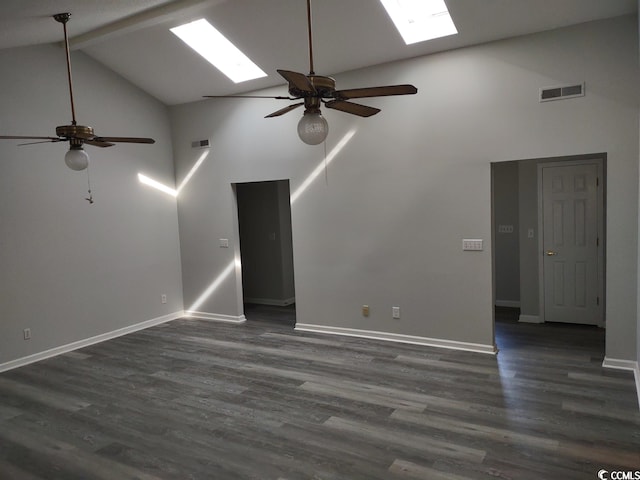 empty room featuring a skylight, high vaulted ceiling, and ceiling fan