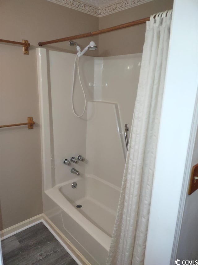 bathroom featuring shower / bath combo with shower curtain and hardwood / wood-style floors