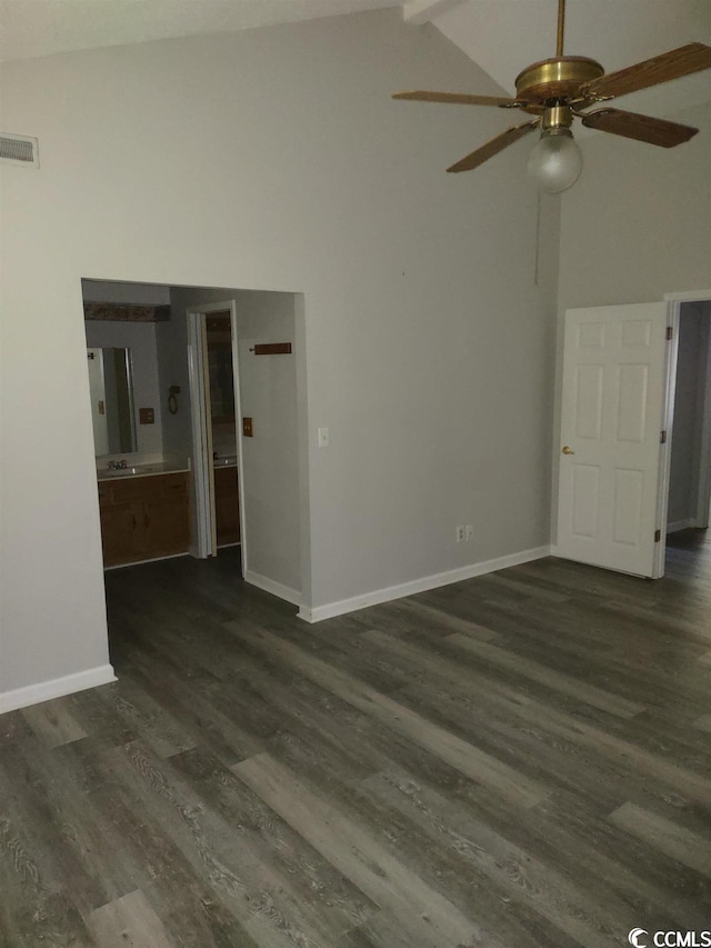 empty room with high vaulted ceiling, ceiling fan, and dark hardwood / wood-style flooring