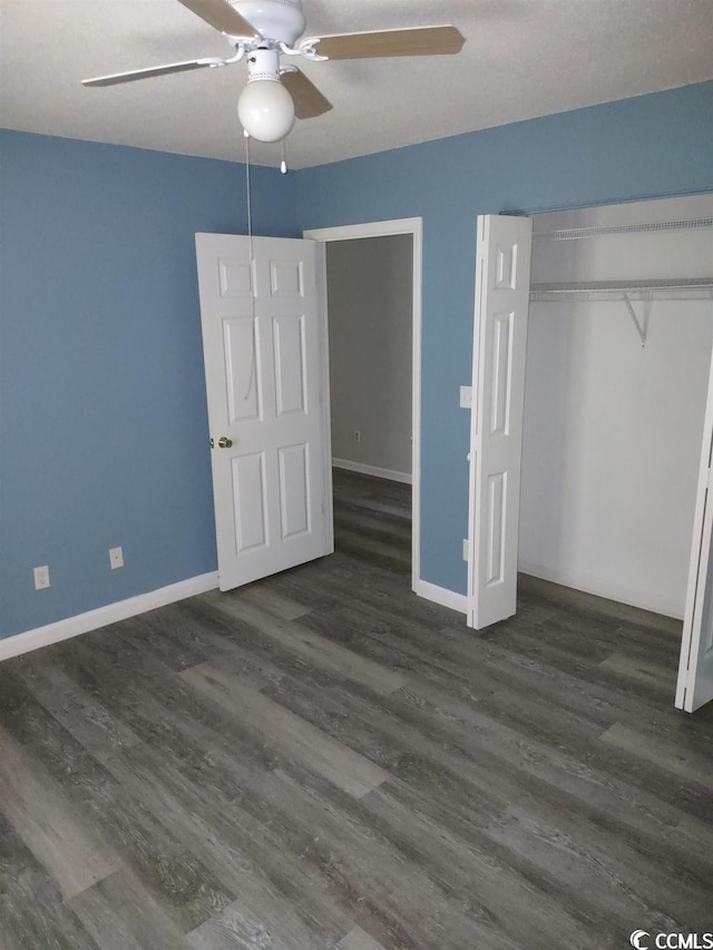 unfurnished bedroom with a closet, ceiling fan, and dark hardwood / wood-style flooring