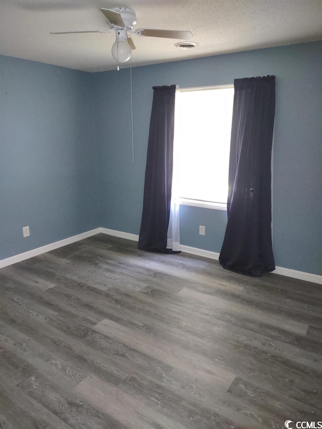 unfurnished room featuring dark hardwood / wood-style flooring and ceiling fan