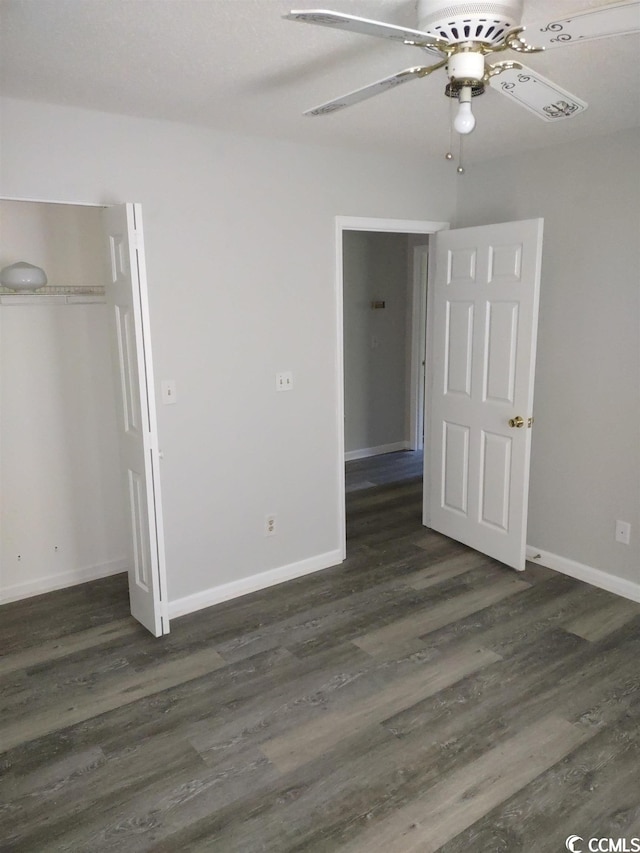 unfurnished bedroom with dark hardwood / wood-style flooring, ceiling fan, and a closet