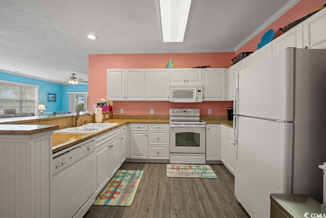 kitchen featuring ceiling fan, white appliances, sink, kitchen peninsula, and white cabinets