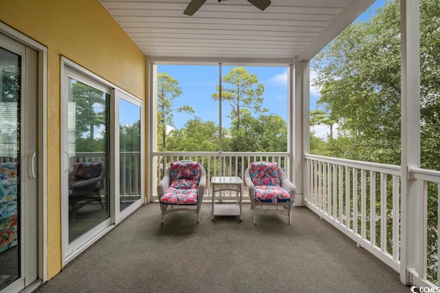 unfurnished sunroom featuring ceiling fan